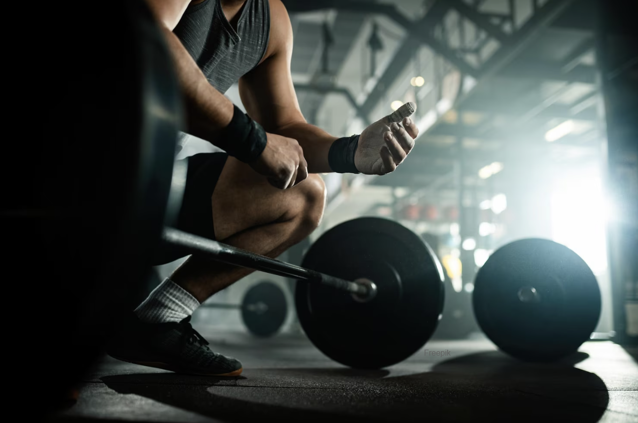 Man in gym crouching over a barbell Weight loss specifically prepared to hep you keep the muscle